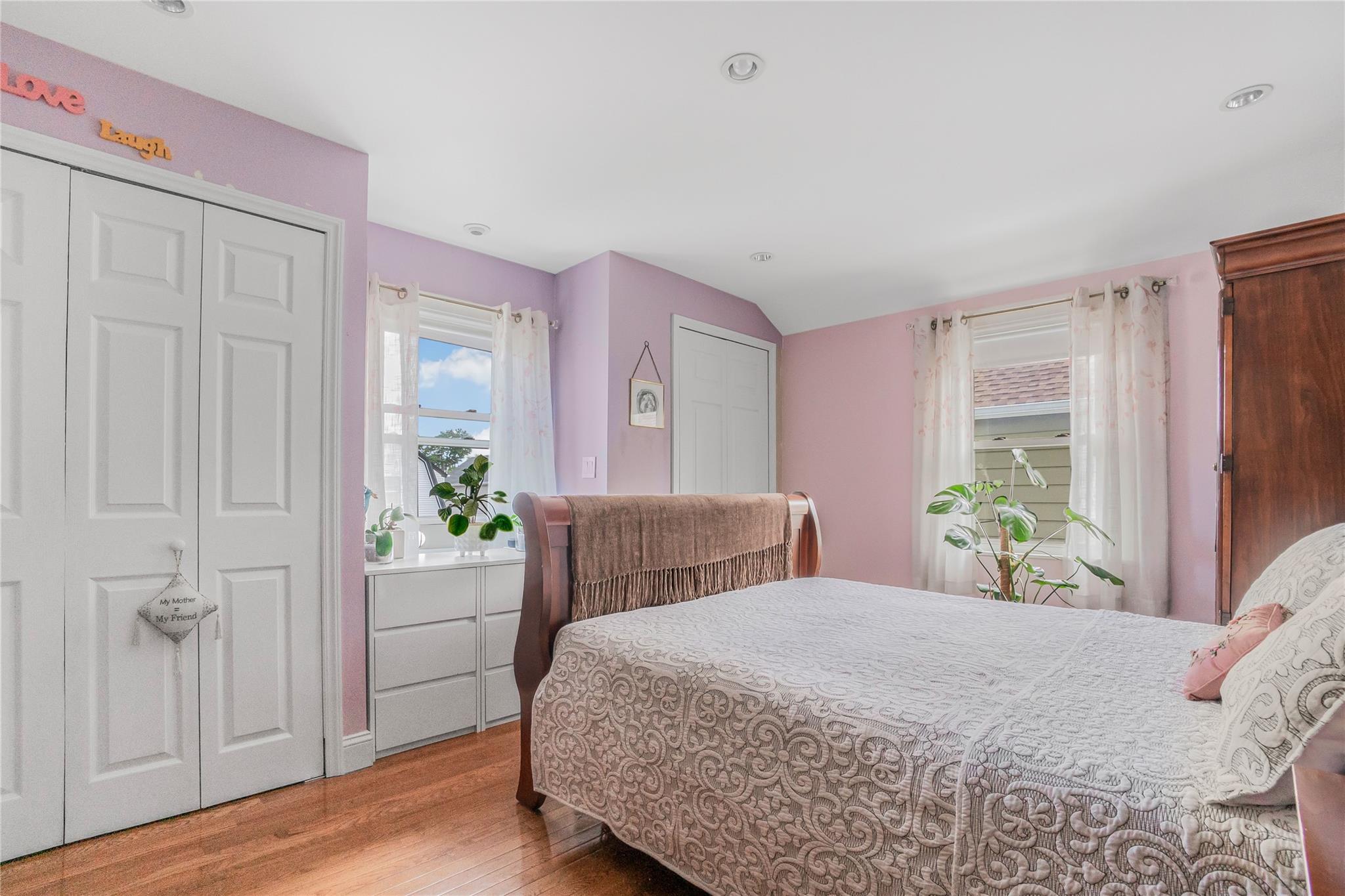 90-21 218th Place Queens, NY 11428 - Photo 9 of 21 a bedroom with a bed and a window