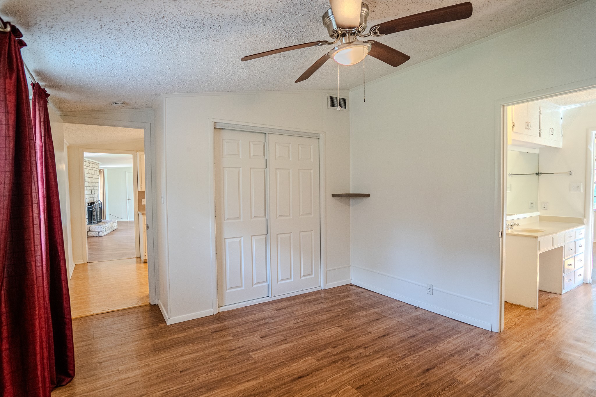 16013 Edwards Drive Austin, TX 78734 - Photo 18 of 18 An inviting room features a built-in closet, a ceiling fan, and durable wood flooring.