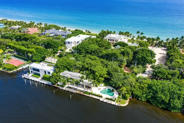 an aerial view of a house with swimming pool and garden