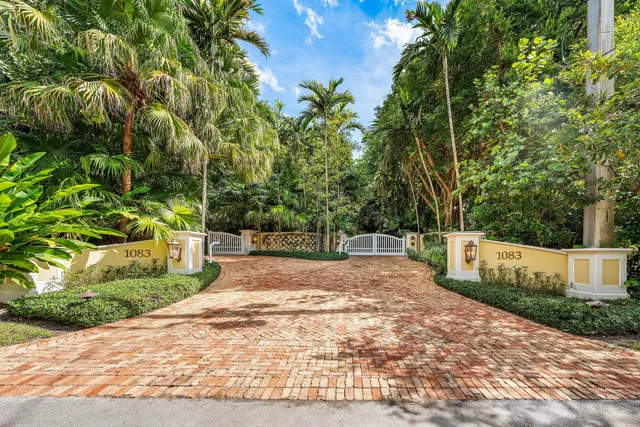 a living room with furniture fireplace and a large window