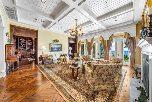 a living room with furniture a rug and a chandelier