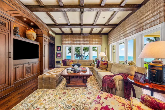 a view of a hallway with wooden floor and a kitchen view
