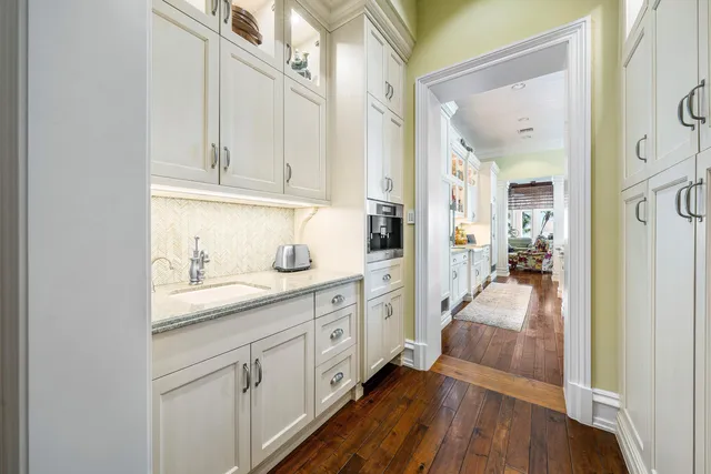 a view of a house with a big yard and palm trees