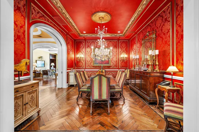 a bedroom with a bed a potted plant and a large window