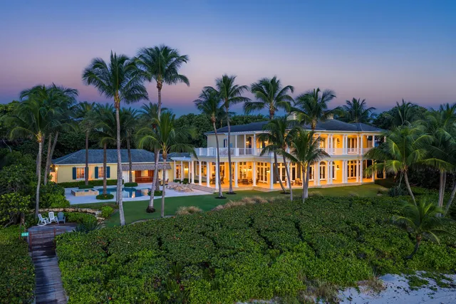 an aerial view of a house with a yard and garden