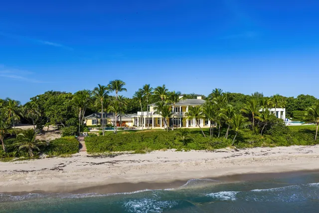 a living room with furniture a chandelier and a large window