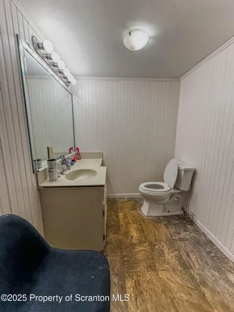 a bathroom with a sink toilet and a mirror