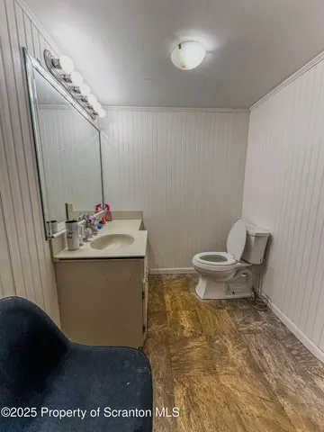 a bathroom with a sink toilet and a mirror