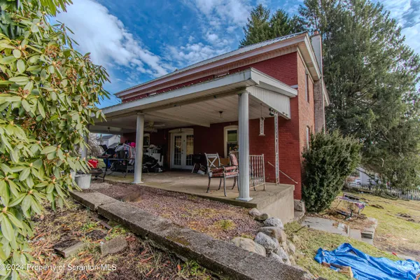 a view of a car park in front of a house
