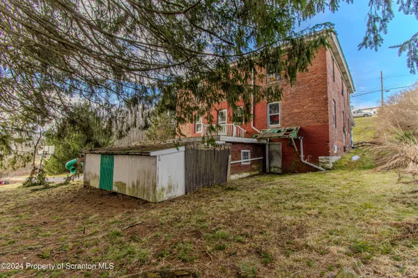 a view of a backyard with large trees