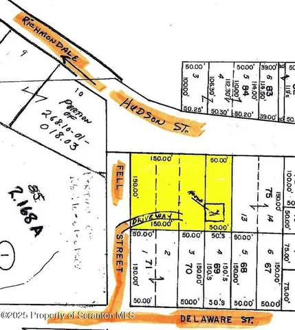 a view of dirt field with large trees