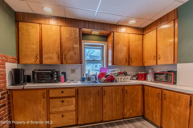 a bathroom with a sink mirror and cabinets