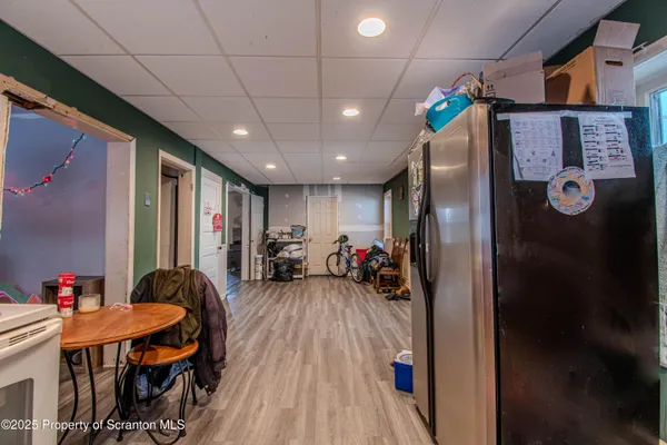 a view of a dining room with furniture a chandelier and wooden floor