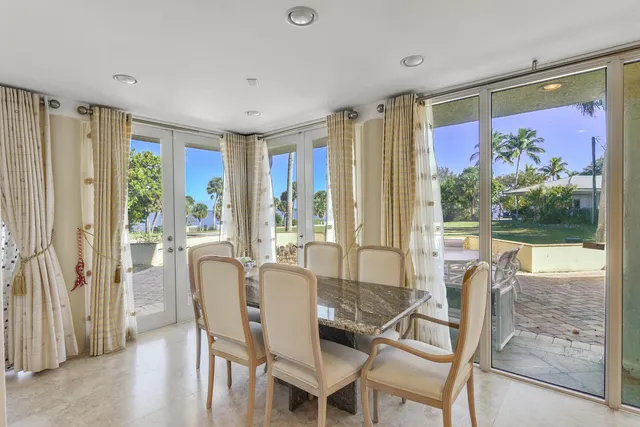 a view of a dining room with furniture large windows and wooden floor