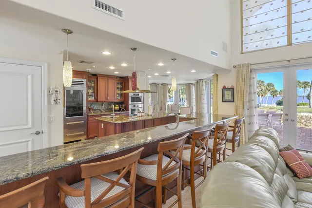 a large dining hall with stainless steel appliances granite countertop a stove and a sink