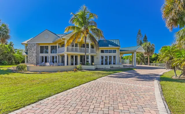 a front view of a house with swimming pool having outdoor seating