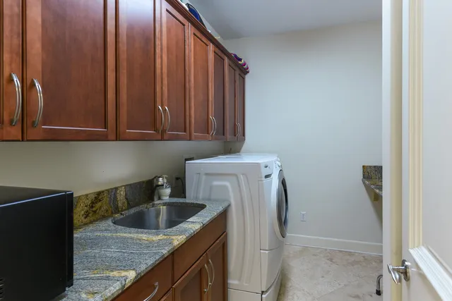 a kitchen with a sink a washer and dryer