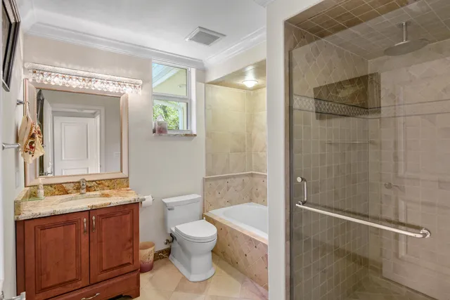 a bathroom with a toilet a sink and shower