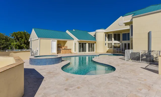 a view of a house with swimming pool and sitting area