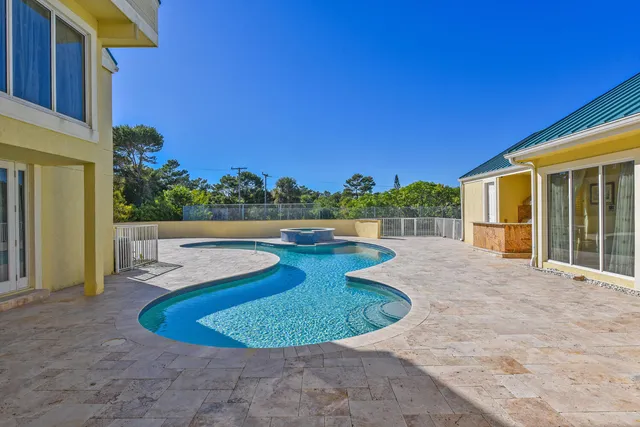 a view of a hallway with wooden floor and windows