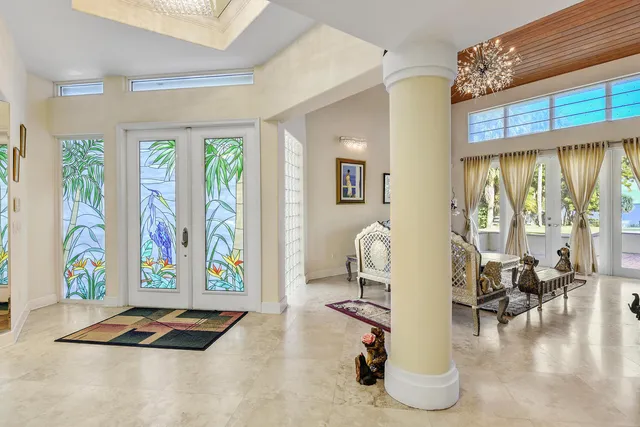 a living room with furniture and a floor to ceiling window
