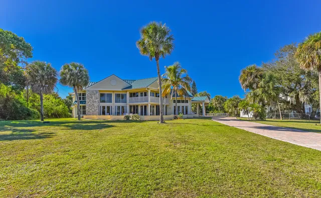 a front view of a house with a big yard