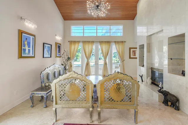 a view of a dining room with furniture and chandelier