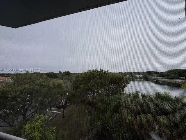 a kitchen with stainless steel appliances granite countertop a sink and a refrigerator