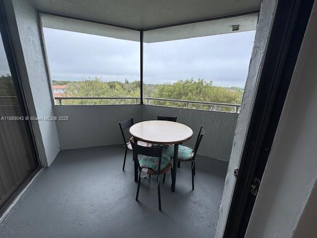 8335 Southwest 152nd Avenue, Unit PH2 Miami, FL 33193 - Photo 17 of 19 a view of a room with a table and chairs