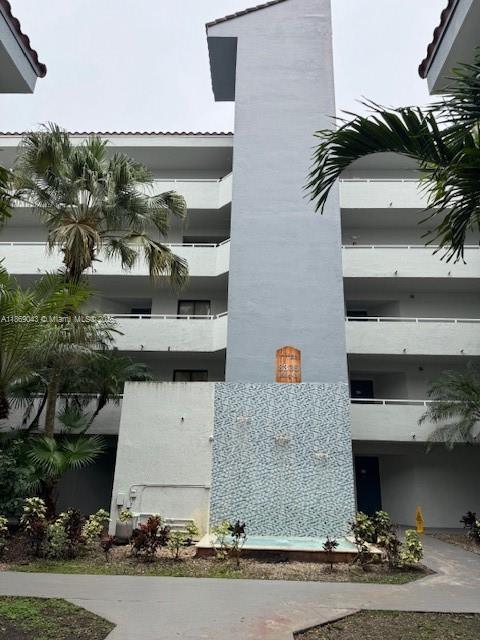 8335 Southwest 152nd Avenue, Unit PH2 Miami, FL 33193 - Photo 19 of 19 front view of house with a yard and car parked