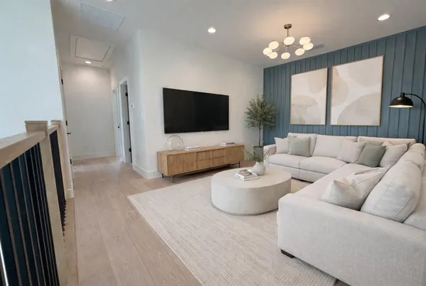 a living room with furniture a large window and a flat screen tv