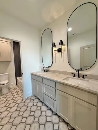 a bathroom with a double vanity sink and a mirror