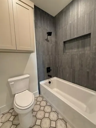a bathroom with a toilet and bathtub