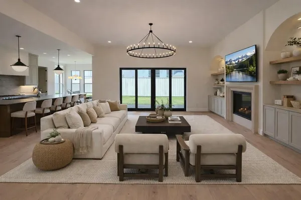 a view of an empty room with a kitchen and a window