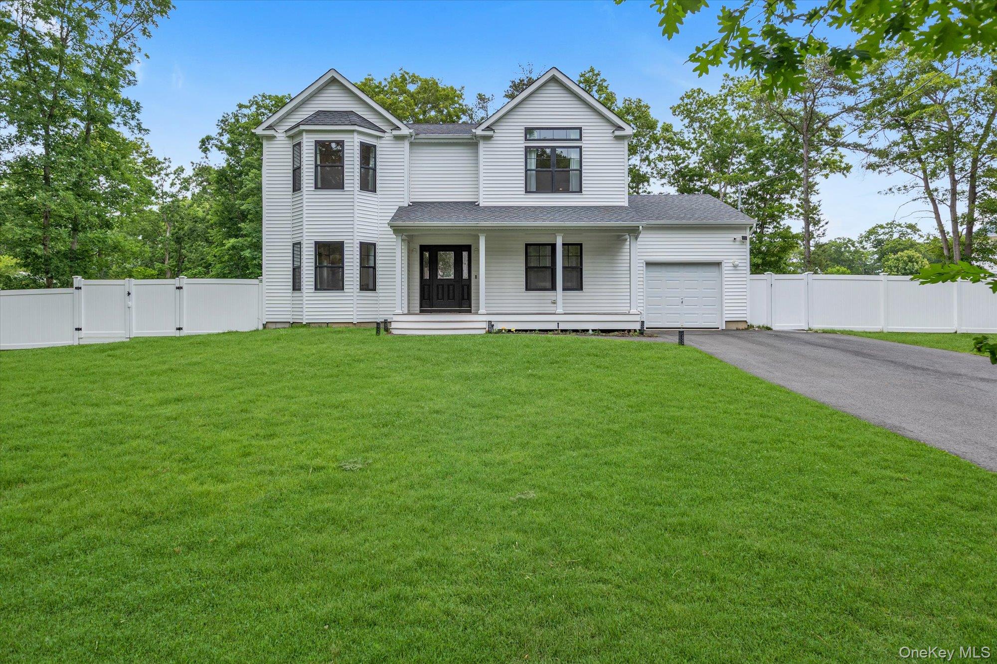 135 Elizabeth Way Ridge, NY 11961 - Photo 1 of 24 a view of a house with a yard