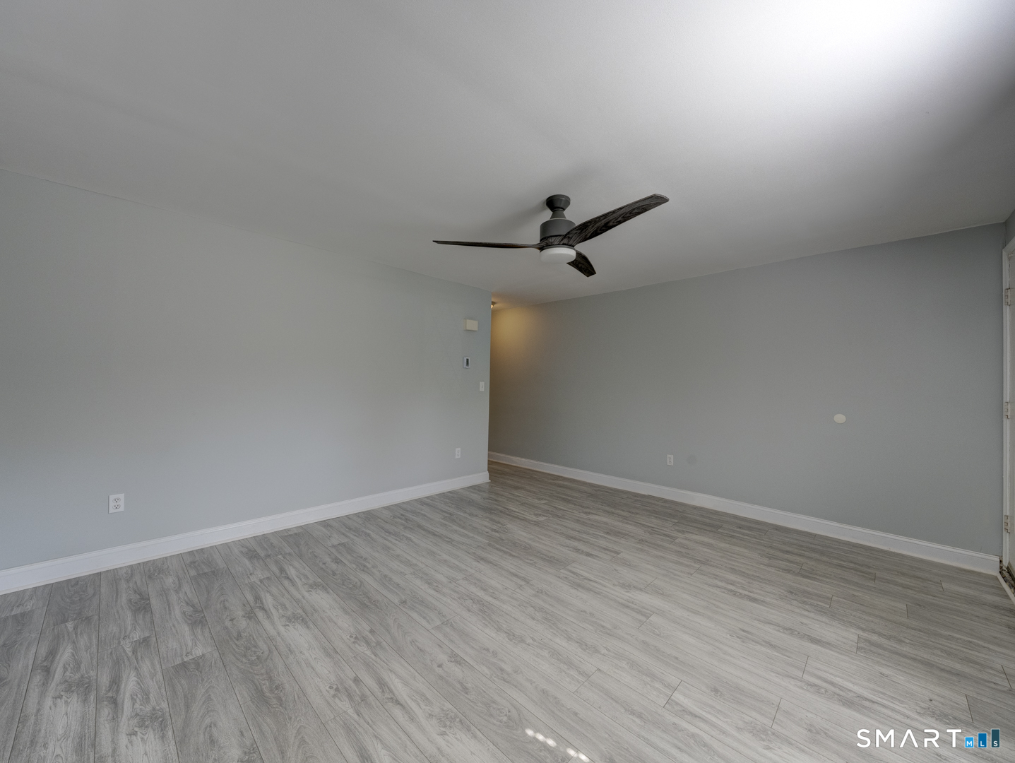 2 Branch Road, Unit 2C Thomaston, CT 06787 - Photo 5 of 26 a view of a room with wooden floor and white walls