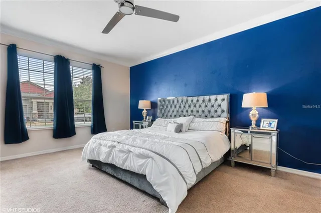 a bedroom with a large bed and a chandelier