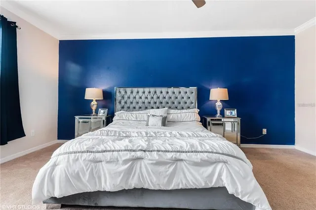 a bedroom with a bed and a wall painting