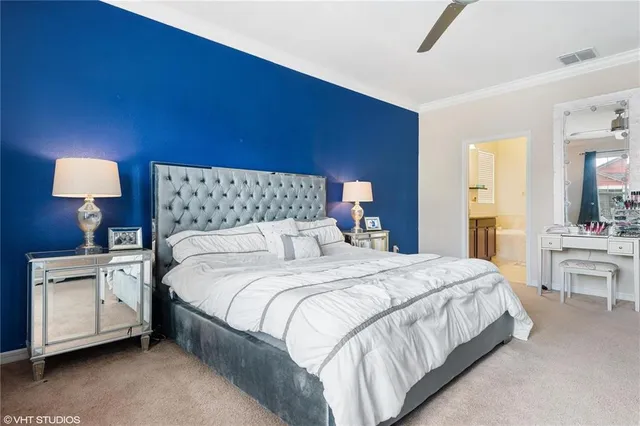 a bedroom with a bed and a lamp