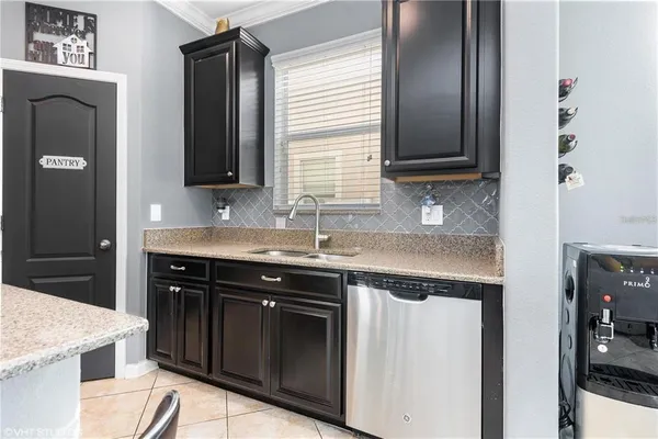 a kitchen with granite countertop cabinets a sink and a stove