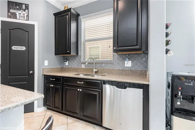 a kitchen with granite countertop cabinets a sink and a stove
