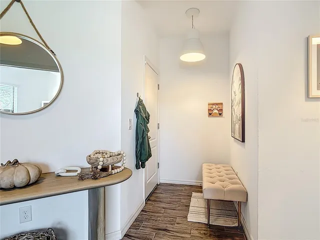 a living room with furniture and a mirror