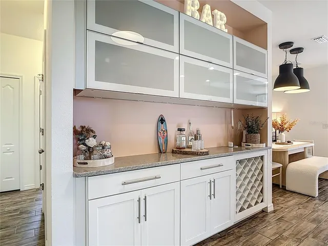 a kitchen with cabinets and window