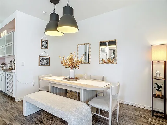 a dining room with furniture and wooden floor