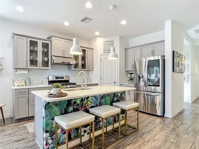 a bathroom with a glass shower door and a sink