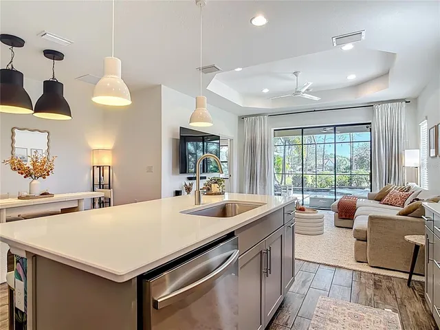 a kitchen with stainless steel appliances a sink stove and cabinets