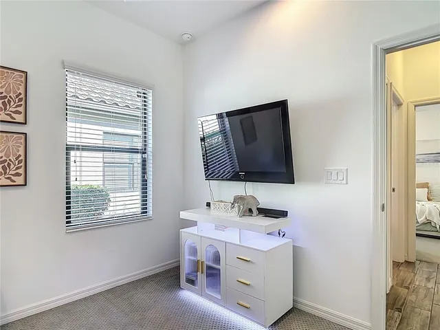 a bedroom with a bed and a mirror