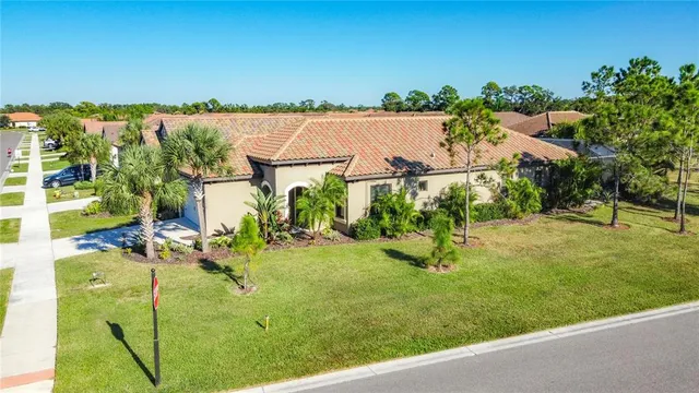 an aerial view of residential houses with outdoor space and trees