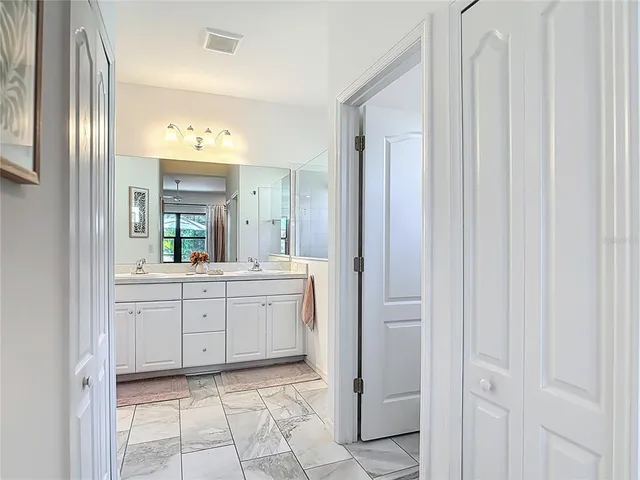 a patio with glass top table and chairs