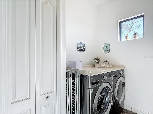 a view of swimming pool with outdoor seating and city view